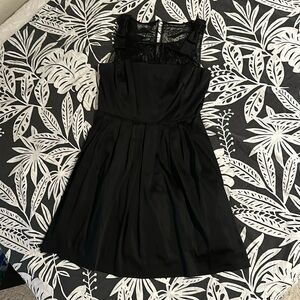 Beautiful Tahari, black cocktail dress with lace detail above the bodice